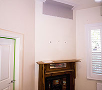 A corner fireplace in a small room