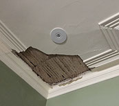 Old lath and plaster ceiling has fallen away from water damage